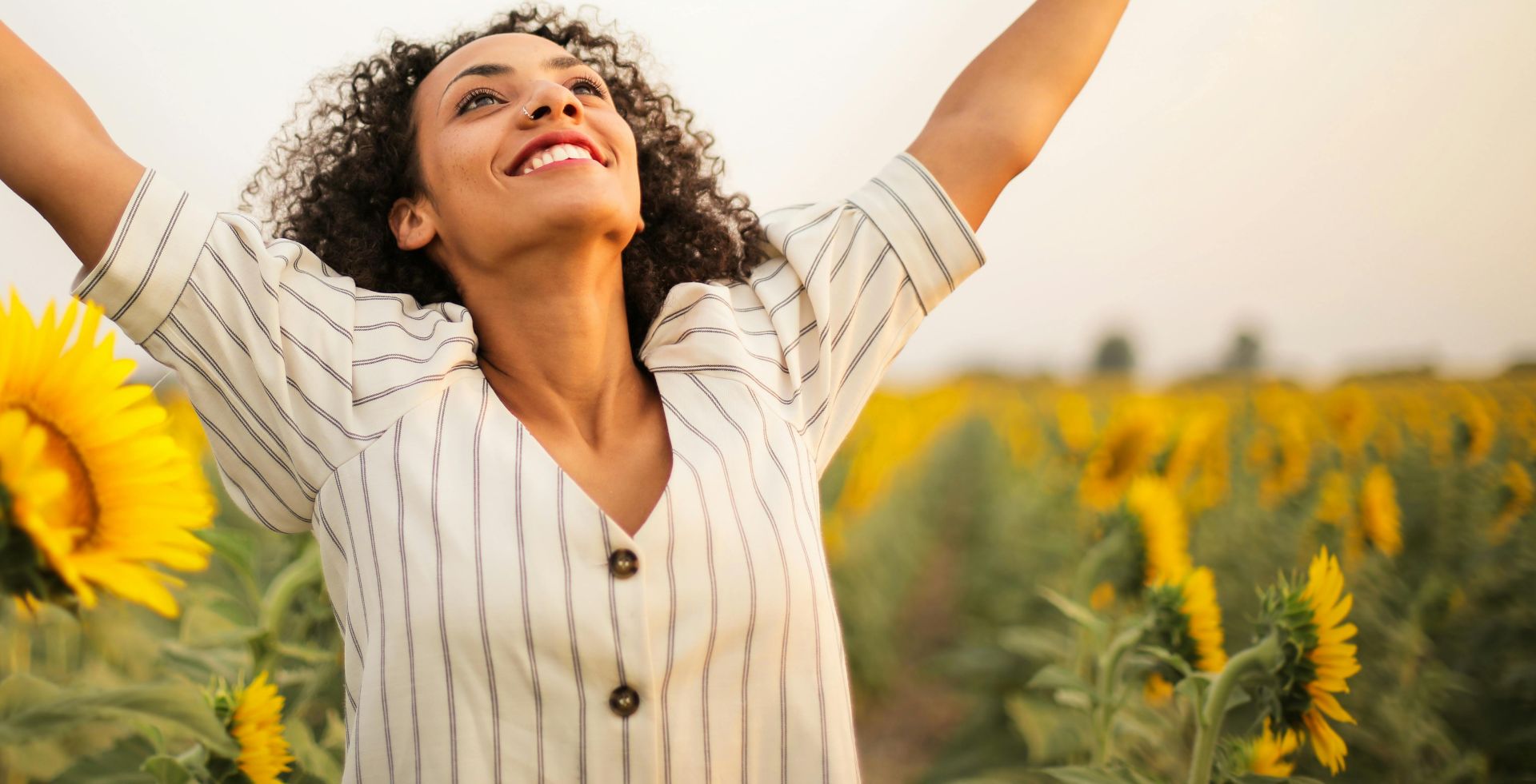 Photo Of Woman Standing On Sunflower Field